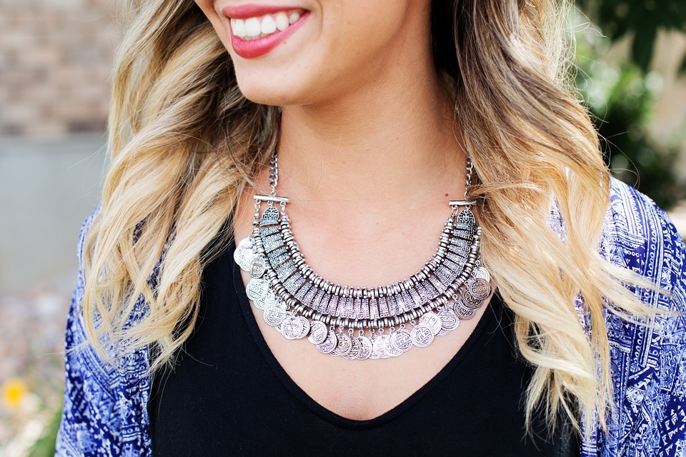 Woman smiling wearing necklace