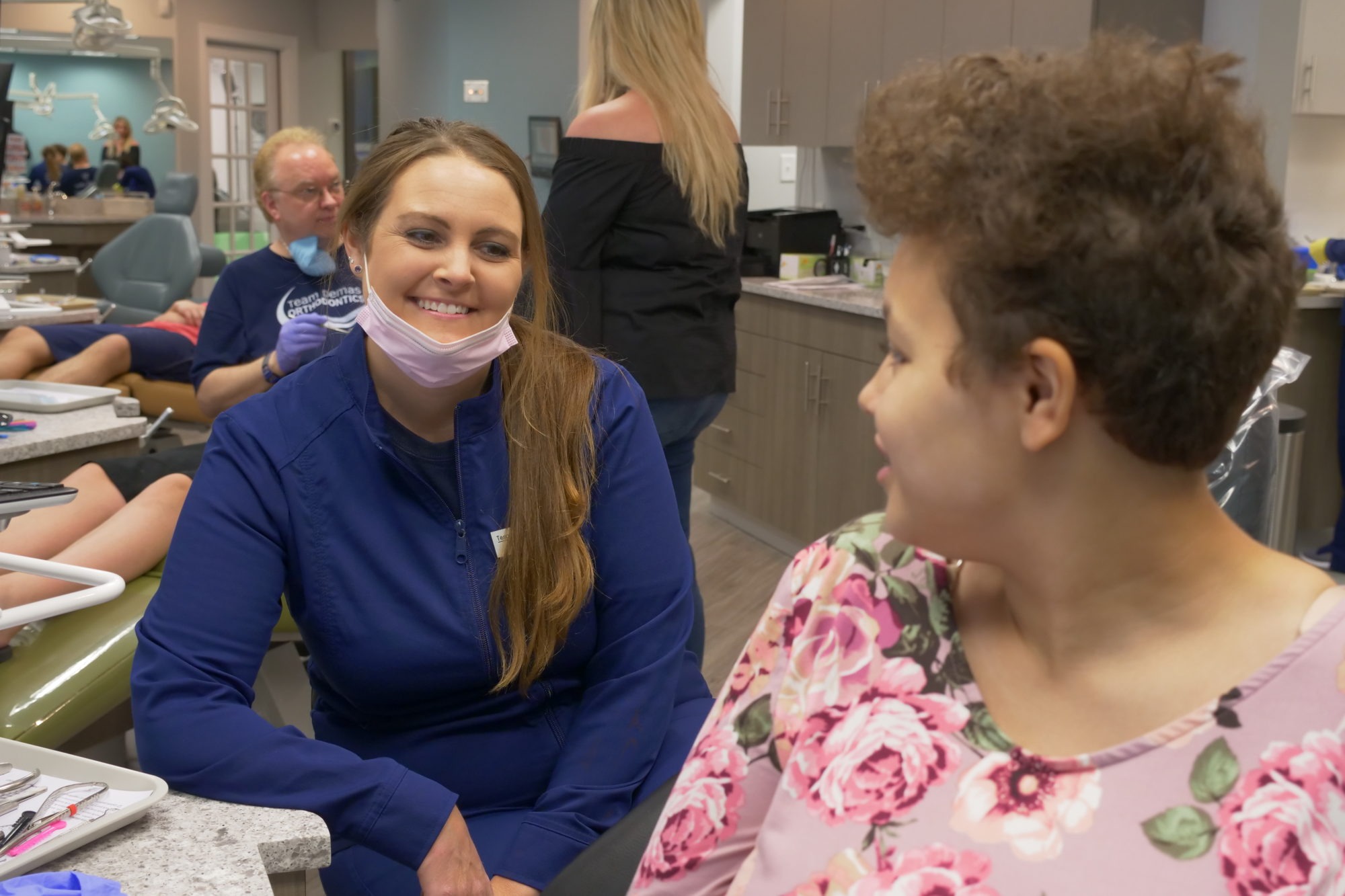 Demas staff talking with a patient