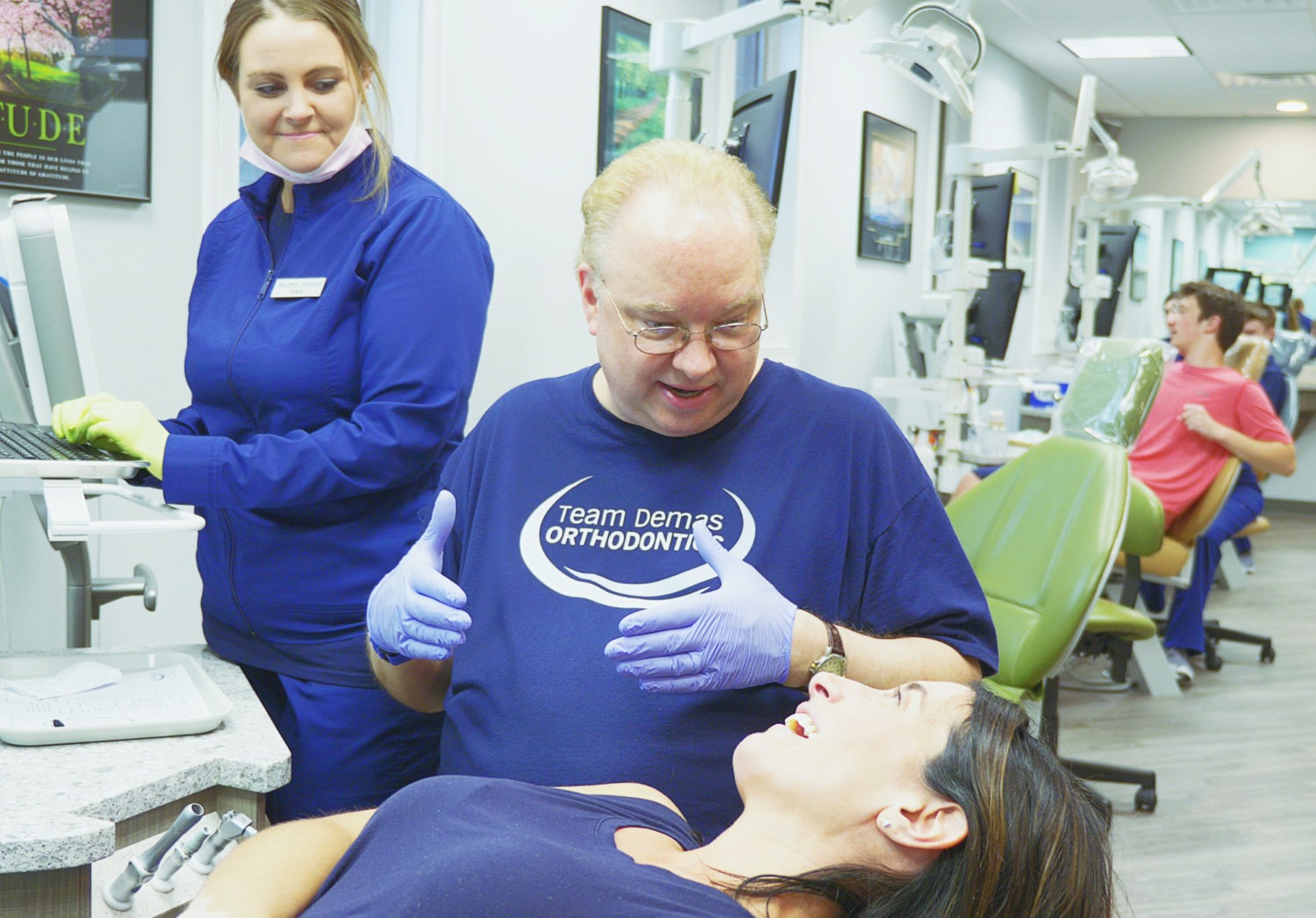 dr. demas helping adult patient during visit